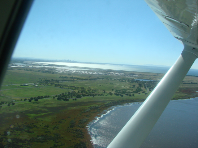 Leaving Pt Cook, a prefect day for the airshow, light northly, warm 28C. Even though its summer the rain we have had makes everything green. Melbourne CBD is in the background as we climb out DSC02520.JPG